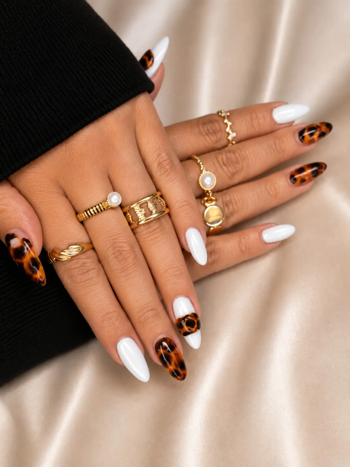 Ivory and tortoise almond nail design with gold jewellery by Marzieh Nail Atelier